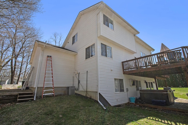 2839 Davista Dr, Highland, MI 48356 - back of property with a hot tub, a deck, a yard, and central air condition unit