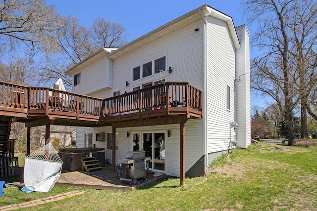 2839 Davista Dr, Highland, MI 48356 - back of property with a hot tub, a wooden deck, and a yard