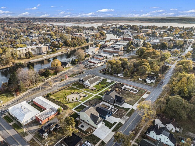 birds eye view of property with a water view and a residential view