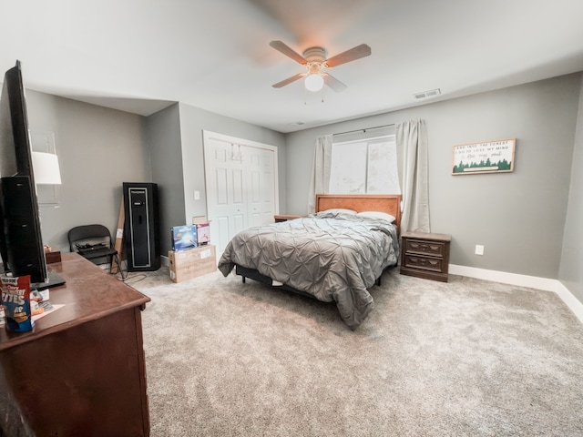 bedroom with ceiling fan, light carpet, visible vents, baseboards, and a closet