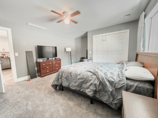 carpeted bedroom featuring ceiling fan, visible vents, vaulted ceiling, and a closet