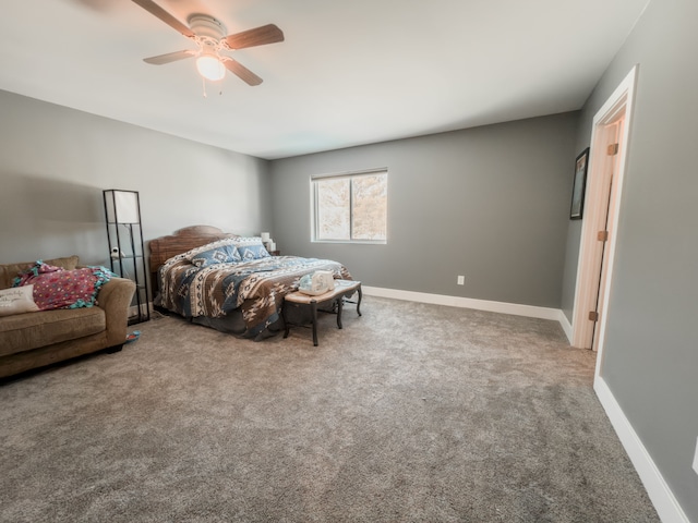 carpeted bedroom with ceiling fan and baseboards