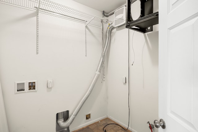 laundry area featuring laundry area, stone finish flooring, washer hookup, and baseboards