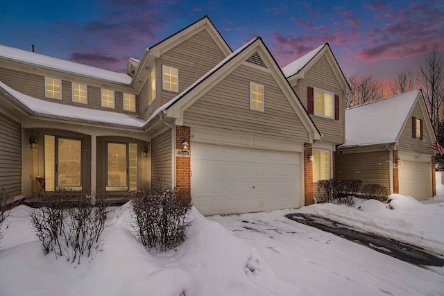 view of front facade with a garage and brick siding