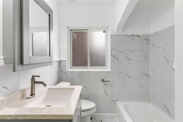 bathroom featuring a tub, marble finish floor, vanity, and toilet