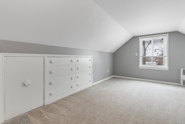 additional living space with carpet floors, vaulted ceiling, and baseboards