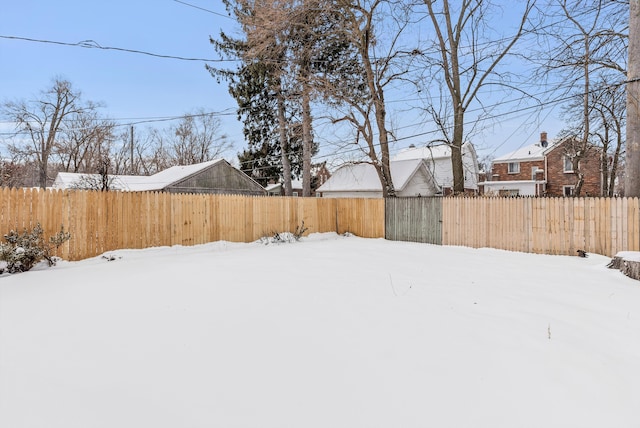 yard layered in snow with fence private yard