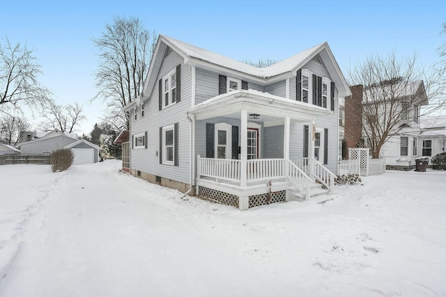 view of front of home featuring covered porch and an outbuilding