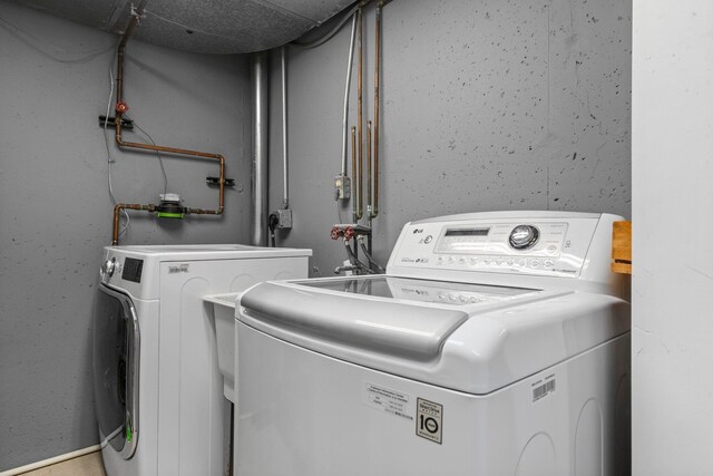 clothes washing area featuring laundry area and independent washer and dryer