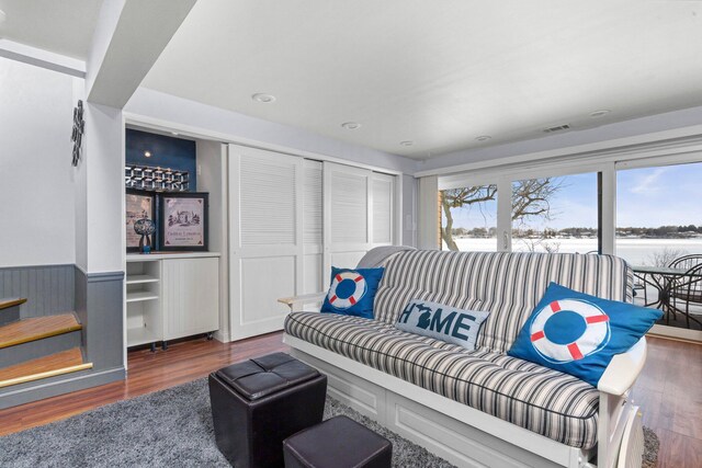 living area with dark wood-style flooring and visible vents