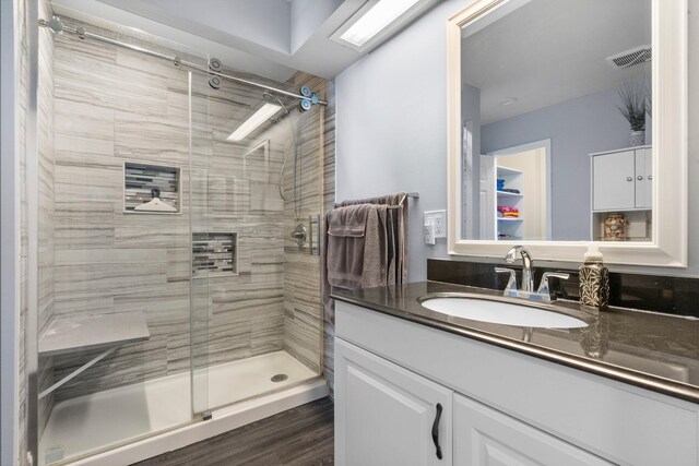 full bathroom featuring visible vents, a shower stall, and vanity