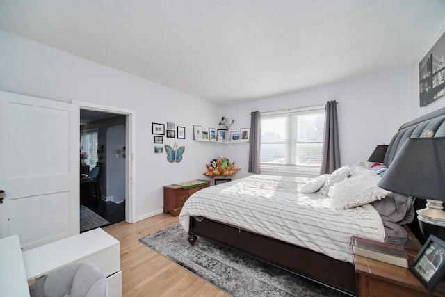 bedroom featuring wood finished floors and baseboards