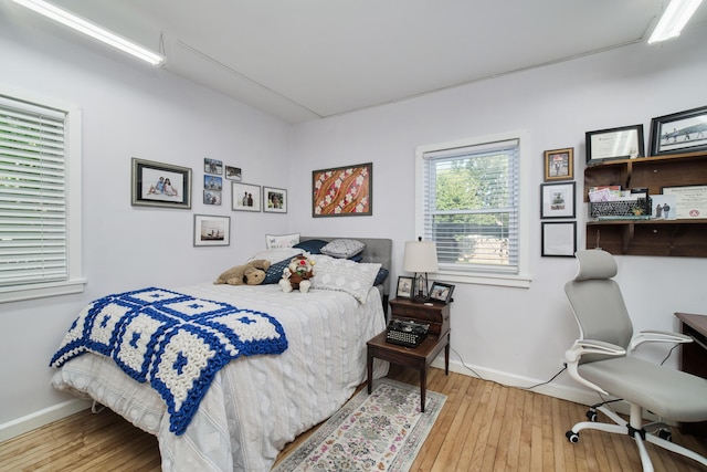 bedroom featuring wood finished floors and baseboards