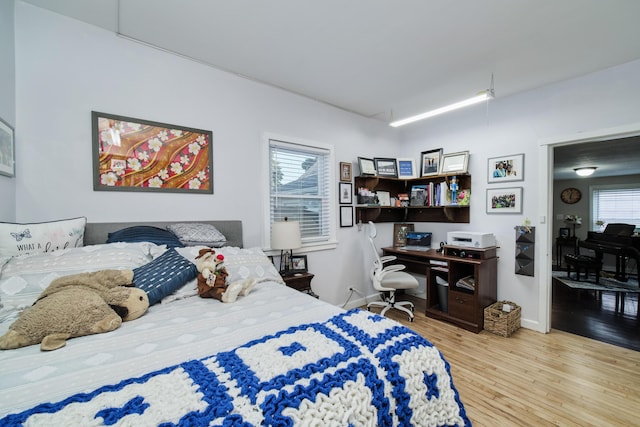 bedroom featuring wood finished floors and baseboards