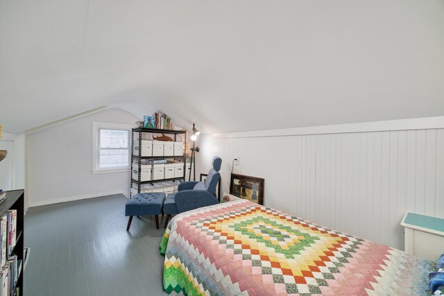 bedroom featuring lofted ceiling and dark wood finished floors