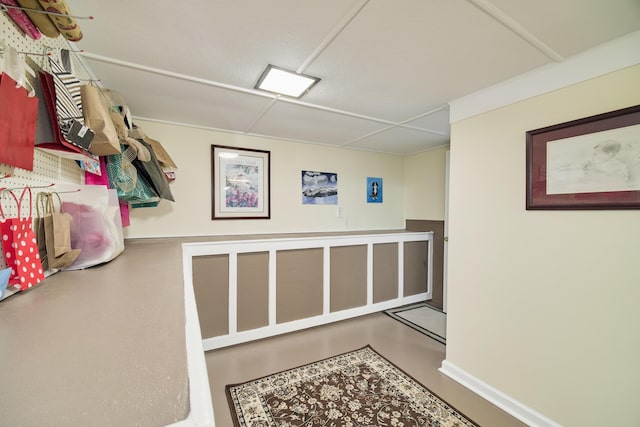 hall with concrete flooring and baseboards