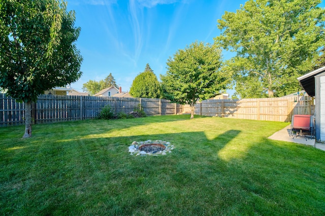 view of yard featuring an outdoor fire pit, a patio area, and a fenced backyard