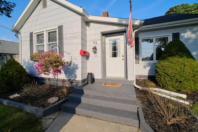 entrance to property featuring a chimney