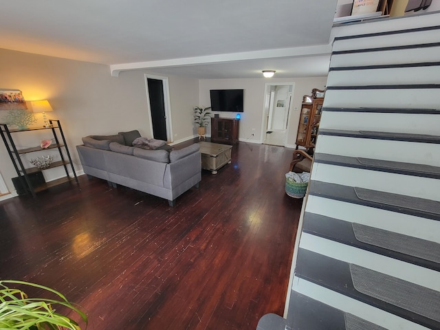 living area with baseboards and wood finished floors