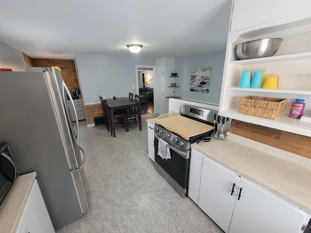 kitchen with stainless steel appliances, light countertops, white cabinets, and open shelves