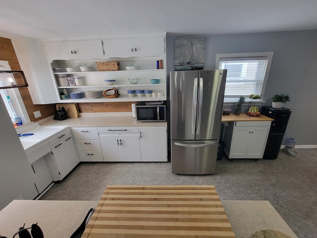 kitchen featuring white cabinets, stainless steel appliances, and light countertops