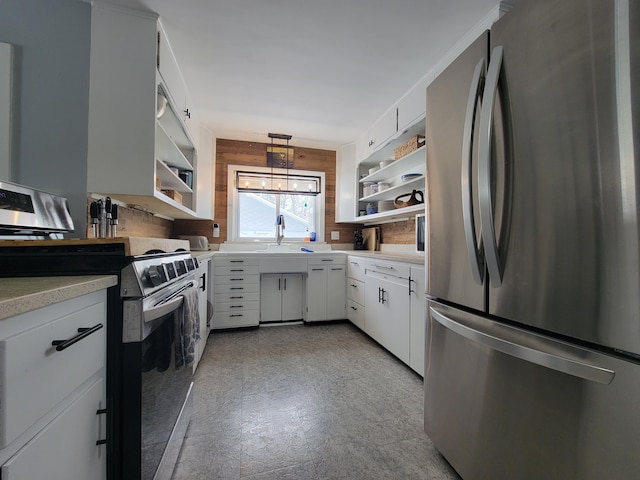 kitchen with white cabinets, light countertops, appliances with stainless steel finishes, open shelves, and decorative light fixtures