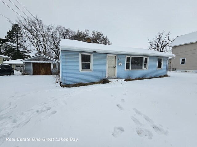 view of front of home with an outbuilding and a garage