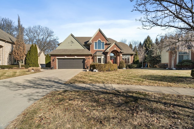 view of front of property with brick siding, a garage, concrete driveway, and a front lawn