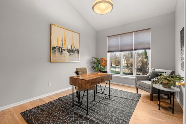 home office featuring lofted ceiling, wood finished floors, and baseboards