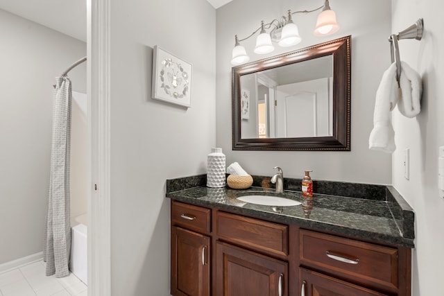 full bathroom featuring tile patterned floors, vanity, and shower / bath combo with shower curtain