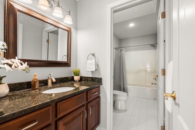 full bath featuring tile patterned floors, toilet, vanity, and shower / bath combination with curtain