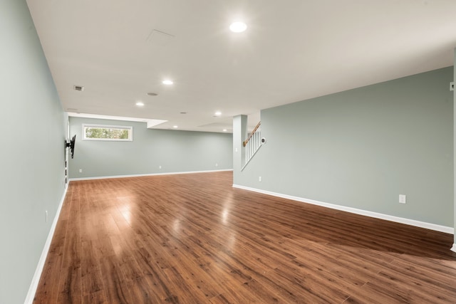 interior space featuring recessed lighting, stairs, baseboards, and wood finished floors