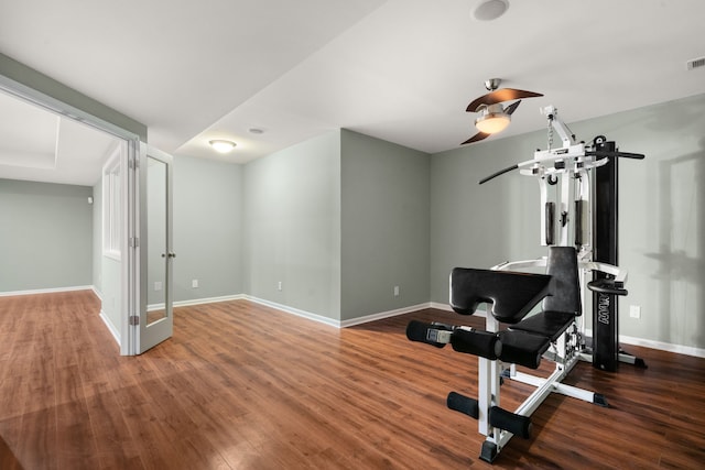 workout room featuring visible vents, baseboards, and wood finished floors