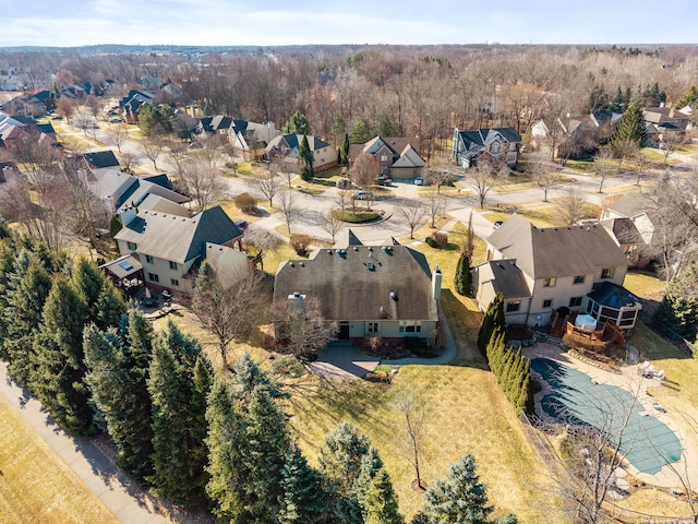 drone / aerial view with a residential view and a view of trees