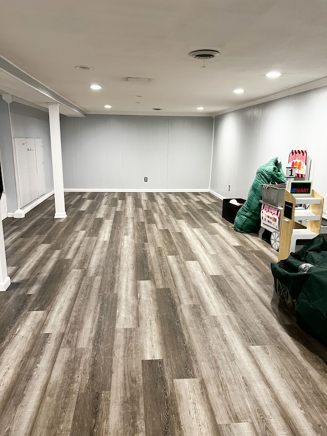 finished basement with recessed lighting, visible vents, and wood finished floors