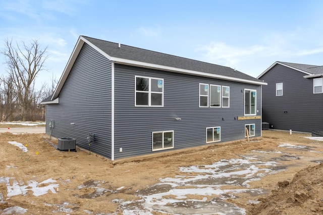 rear view of property featuring central AC