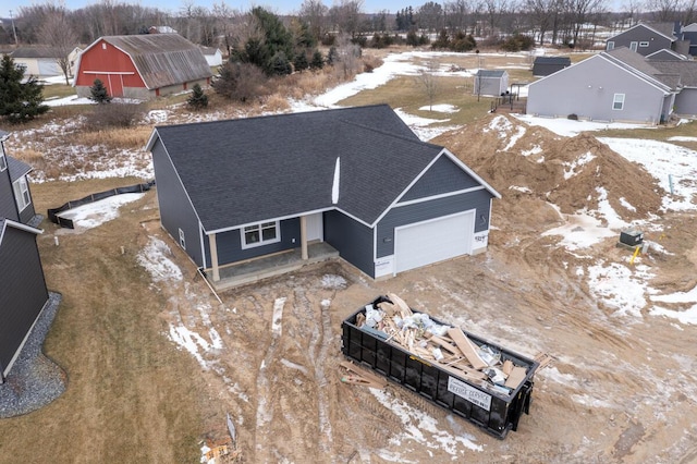 snowy aerial view with a residential view