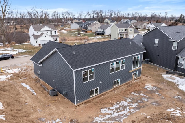 snowy aerial view featuring a residential view