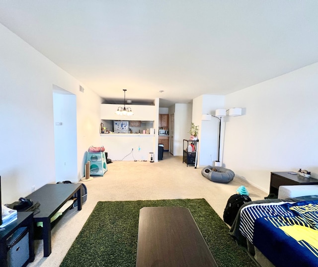 interior space with carpet, visible vents, and an inviting chandelier