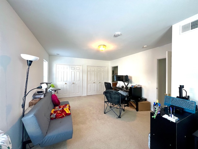 home office with light carpet and visible vents