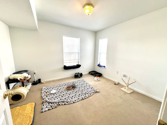 workout room featuring carpet floors and baseboards