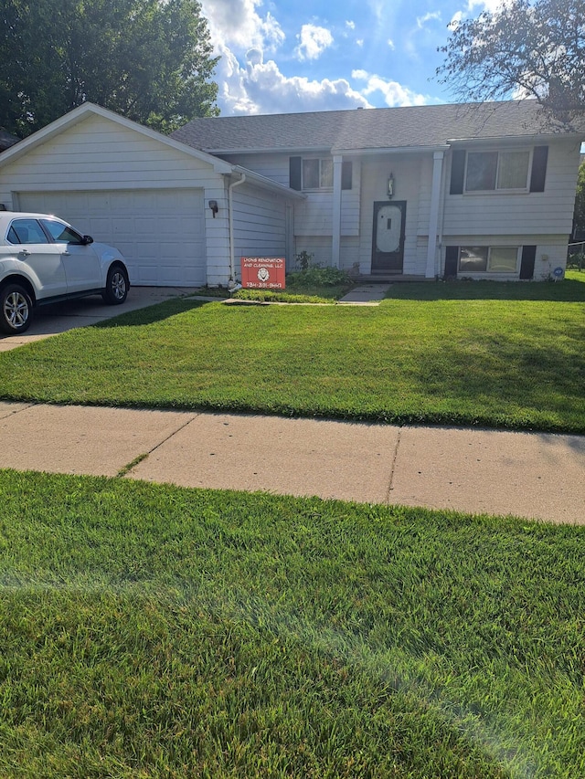 bi-level home featuring driveway, a front lawn, and an attached garage