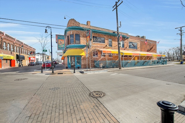 view of street featuring sidewalks, curbs, and street lights