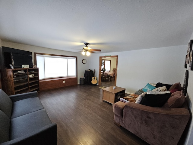 living room with dark wood-style flooring and ceiling fan