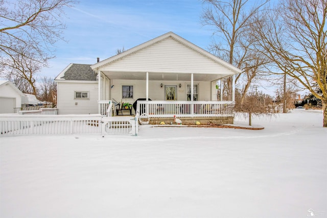 view of front of property featuring a porch, roof with shingles, and fence