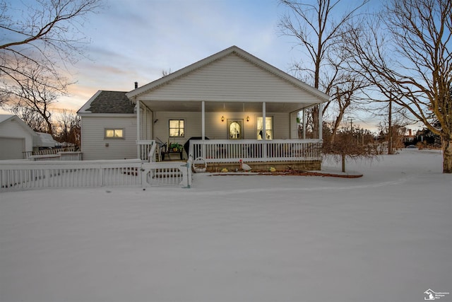 view of front facade with covered porch and a fenced front yard