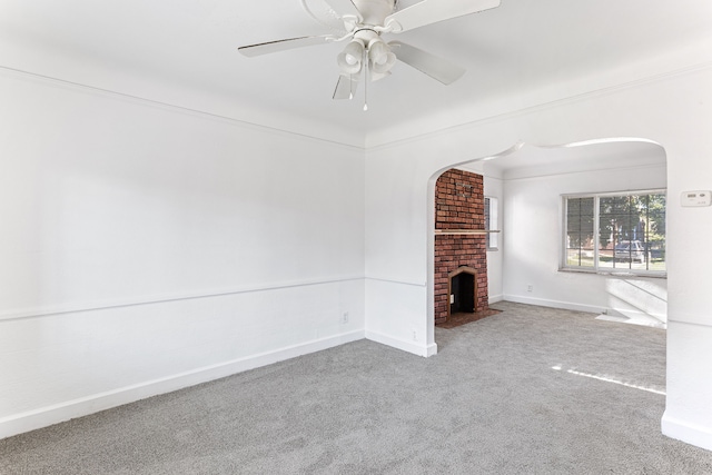 unfurnished living room featuring a fireplace, carpet flooring, a ceiling fan, and baseboards