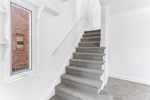 staircase with carpet and baseboards