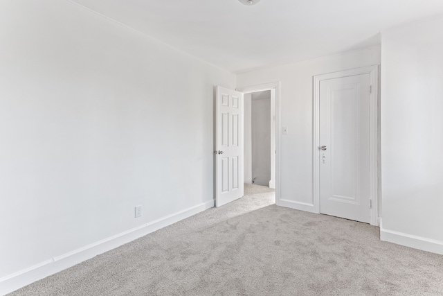 empty room with light carpet and baseboards