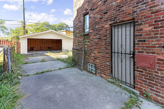 exterior space with a garage, brick siding, and fence